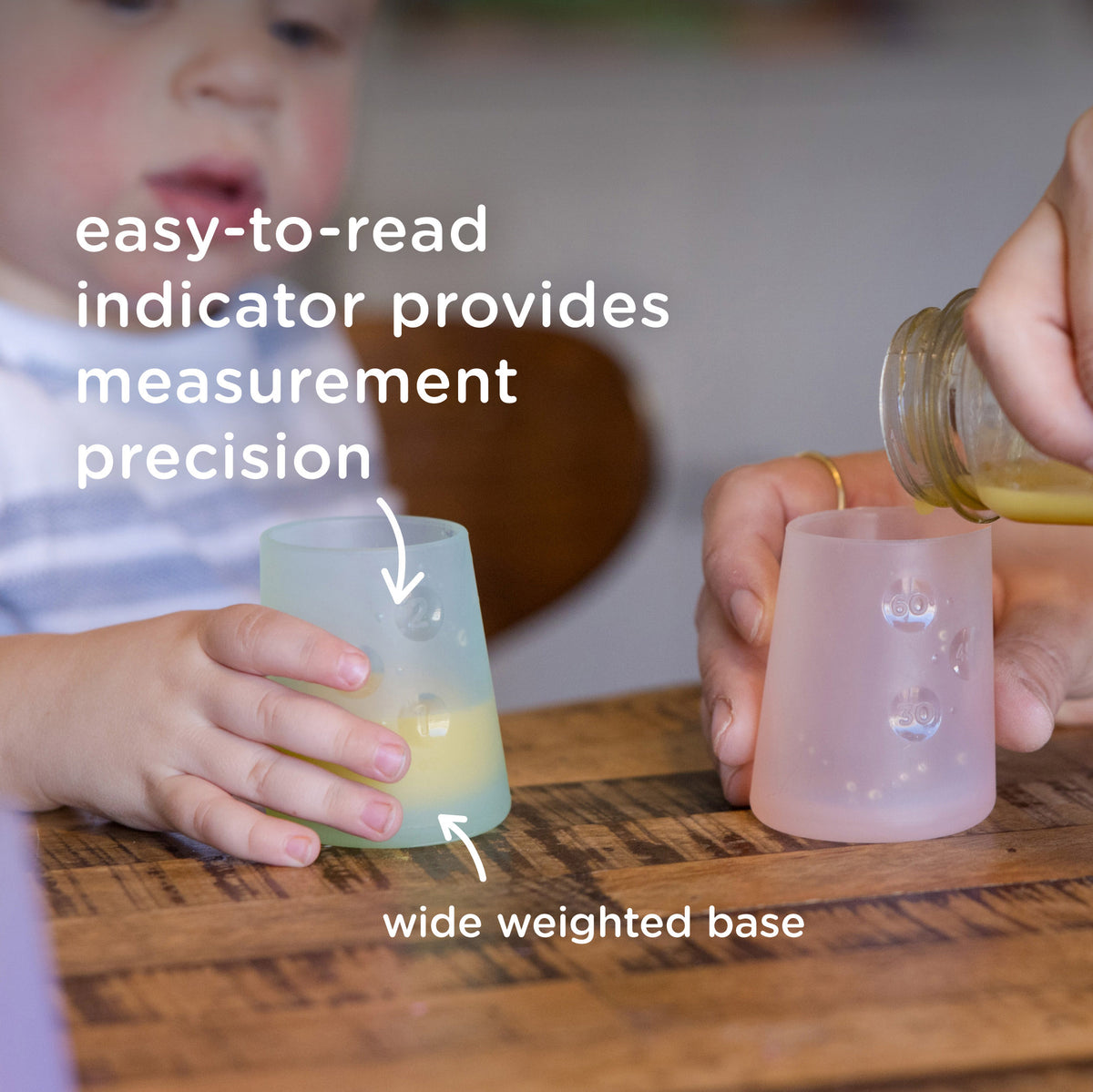 Translucent baby training cup showing liquid level through easy to read measurement indicator lines and a wide weighted base