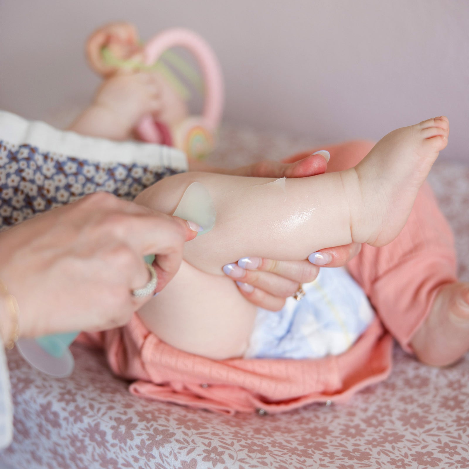Olababy mint green silicone diaper cream applicator standing upright on its integrated suction cup base.